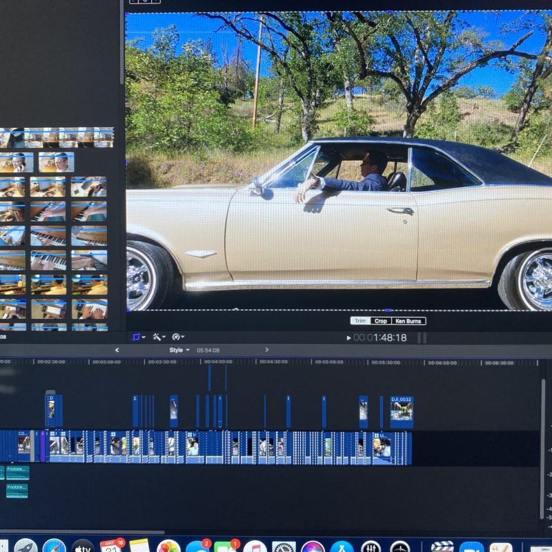 Video editing timeline with cinematic footage of a classic car driving, used for media production in Medford Oregon